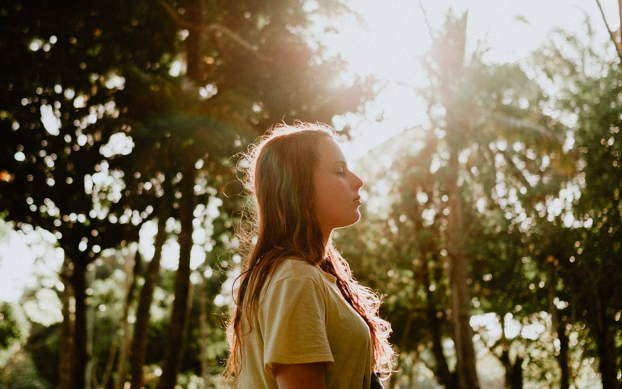 a girl is listening with her eye closed