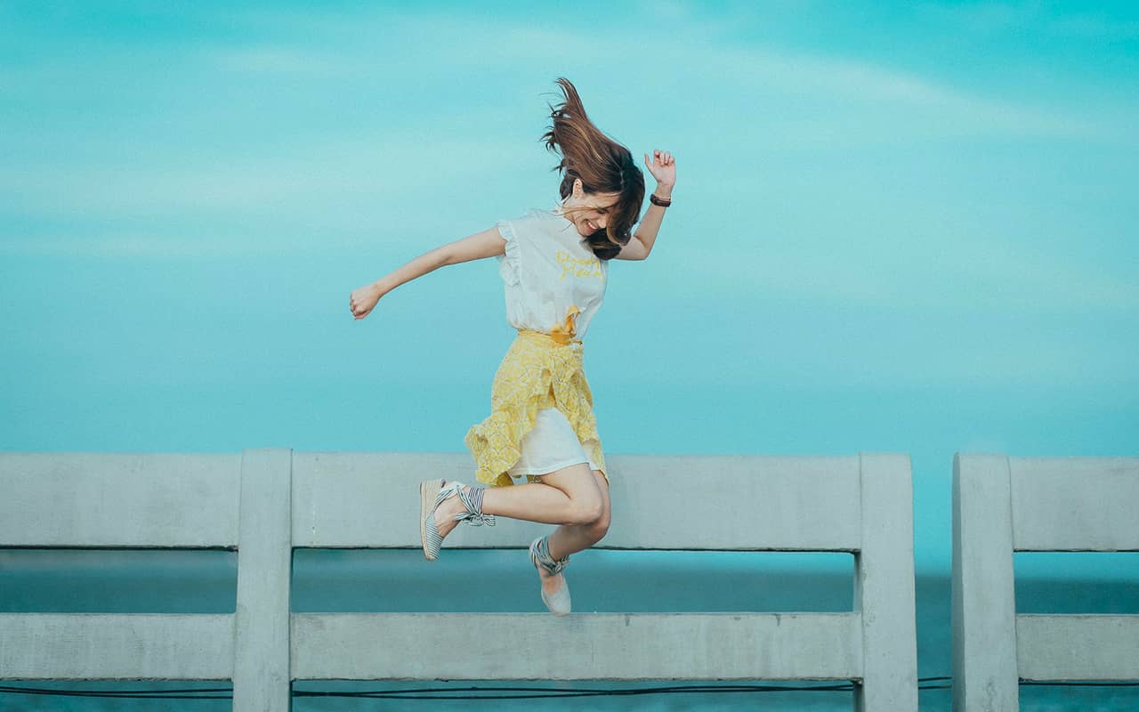 a happy woman is jumping