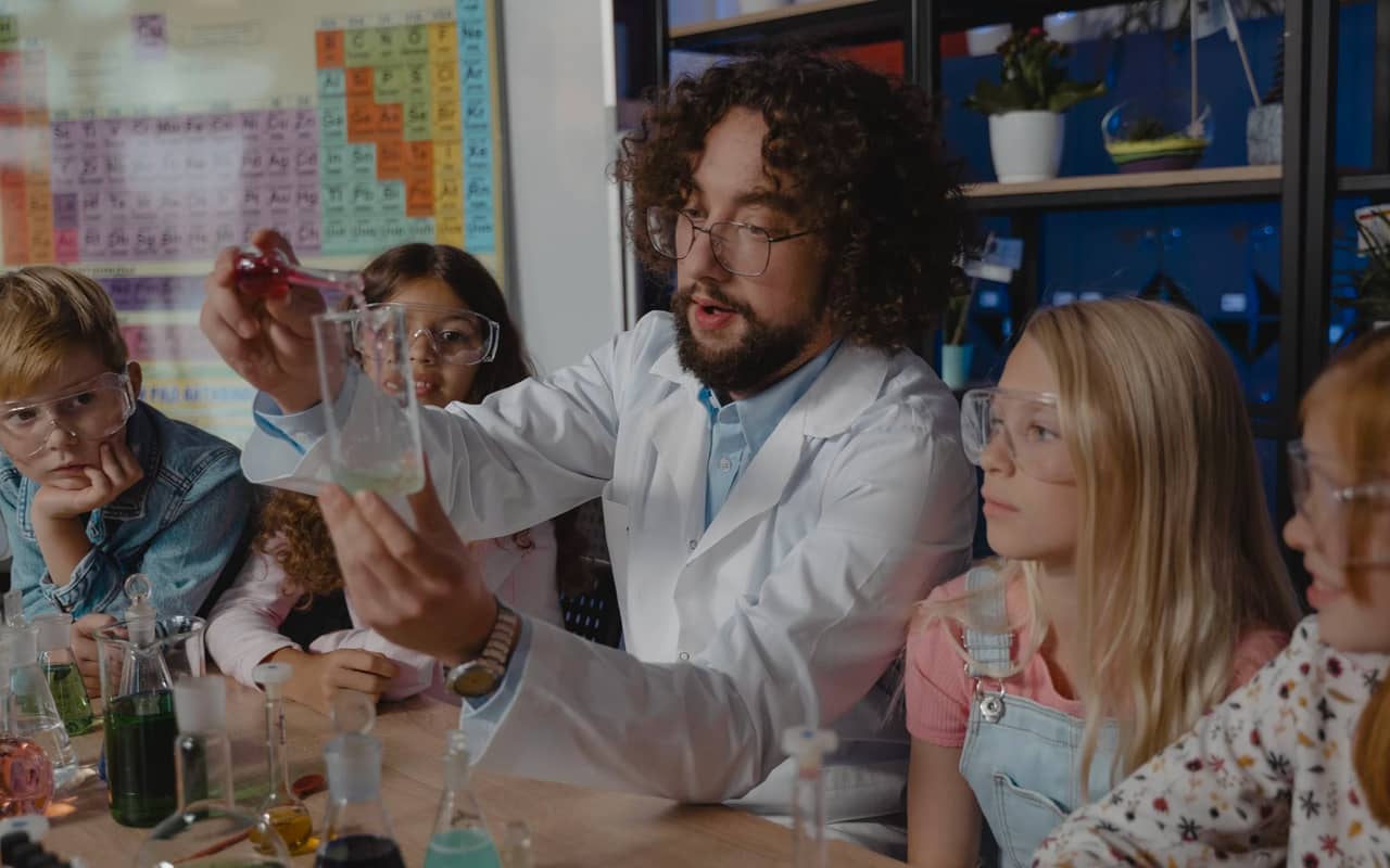 a teacher is teaching chemistry