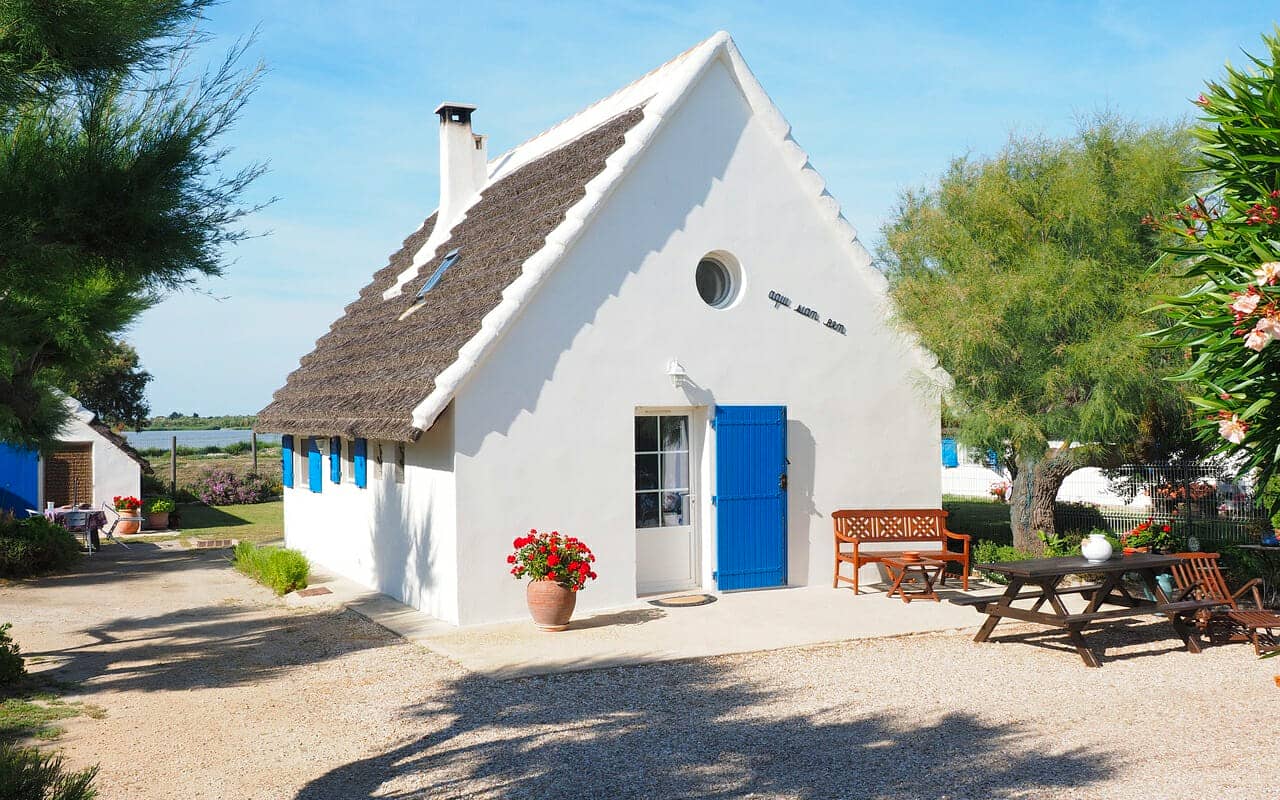 a white wall house with a blue door