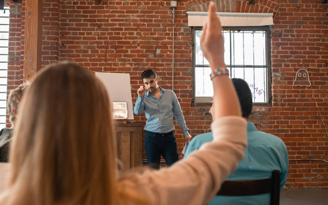 a woman asks questions in a class