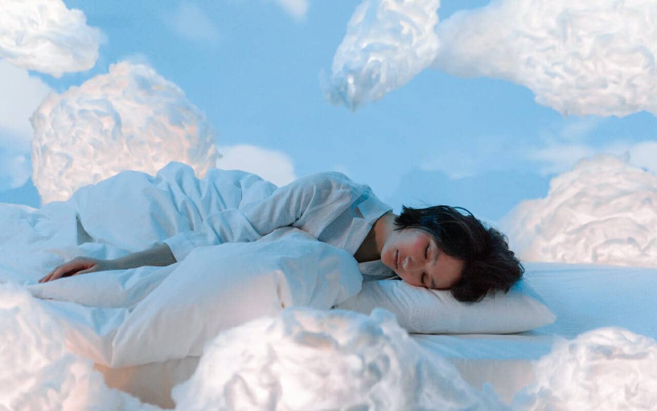 a woman is dreaming with white clouds around