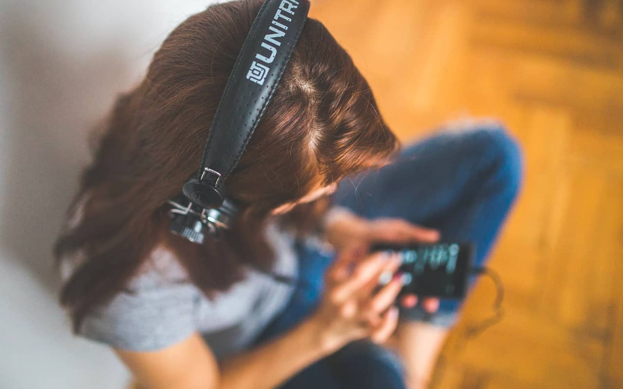 a woman is listening songs