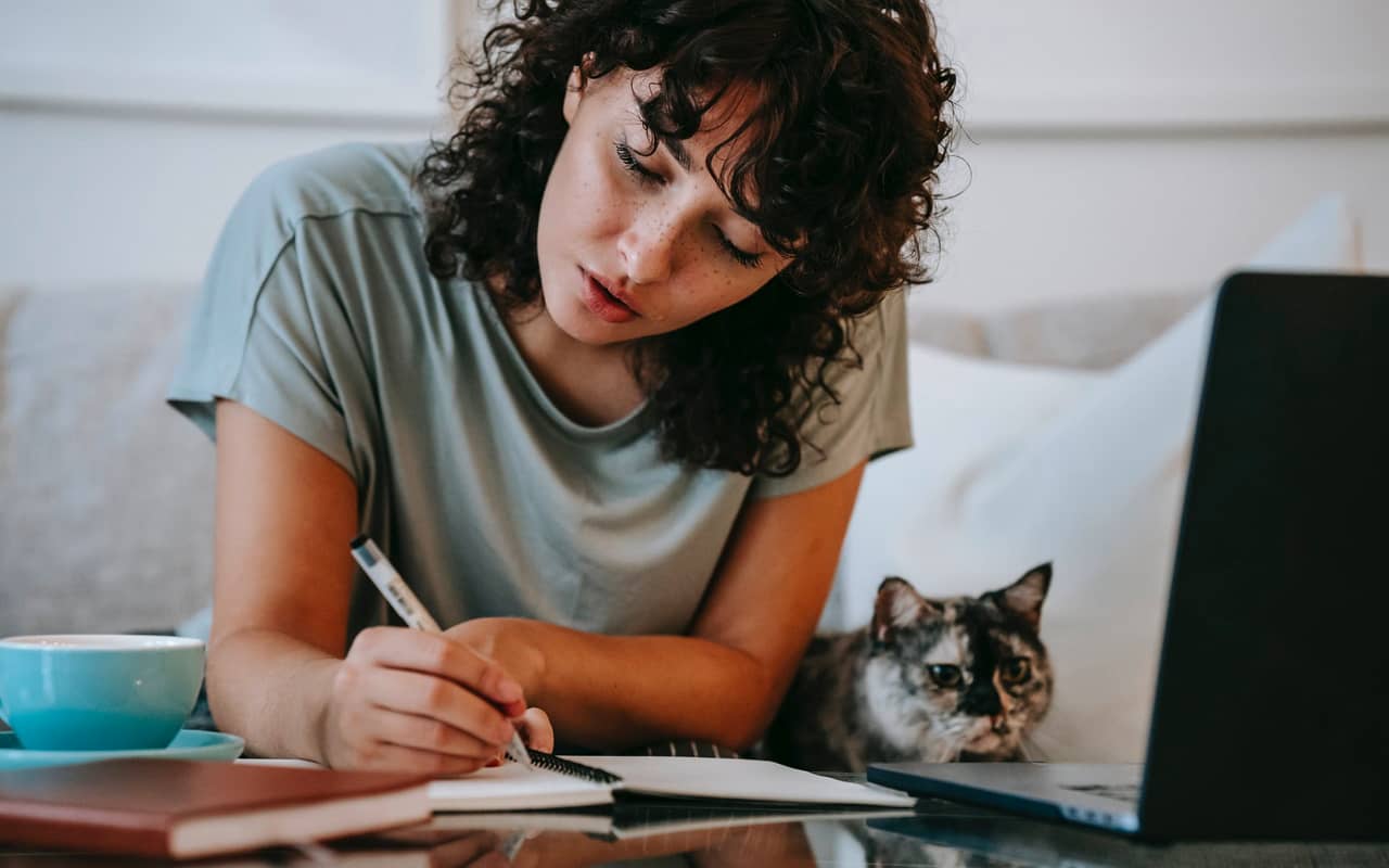 a woman is writing and learning