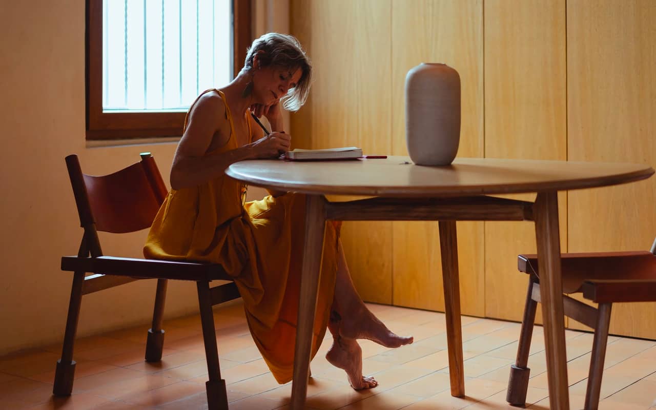 a woman is writing in a room