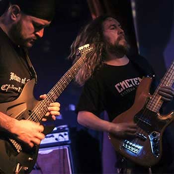 Anthony Metivier and Sergio Klein playing guitar and bass on stage feature post