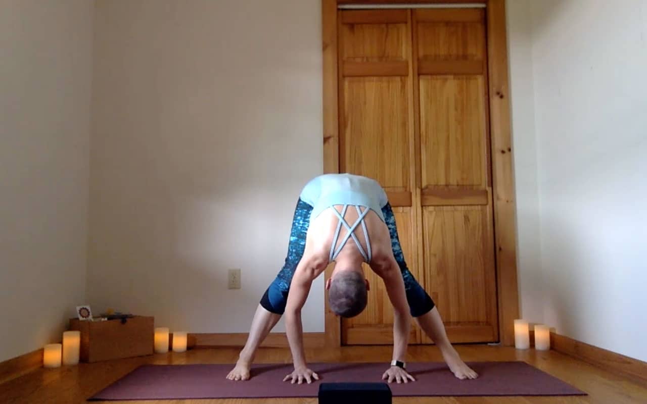 The post author demonstrates Prasarita Padottanasana (Wide-Legged Forward Fold).