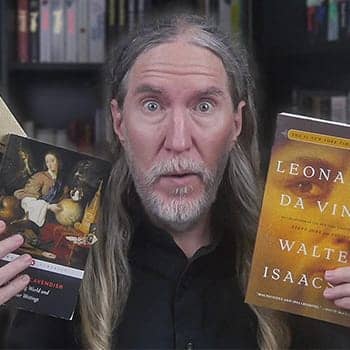 Autodidact personality traits feature image of Anthony Metivier holding books about autodidacts