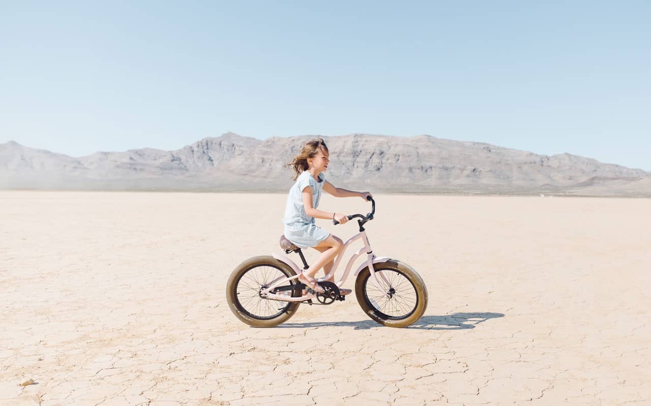 A girl riding her bike in the desert; an example of procedural memory.