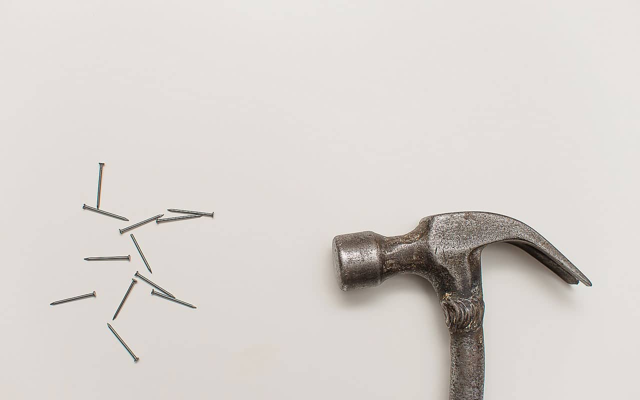 A hammer and a pile of nails.
