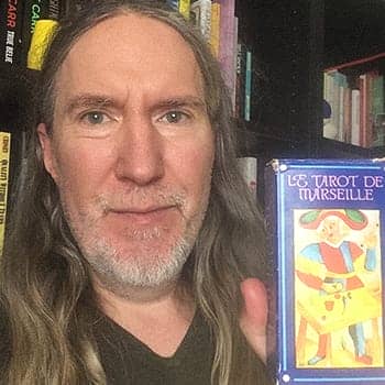 Anthony Metivier holding a Tarot deck in its box as the feature image for how to memorize tarot cards