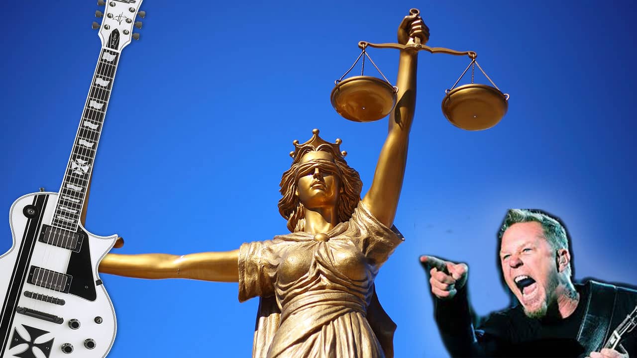 James Hetfield pointing at statue of justice with his guitar