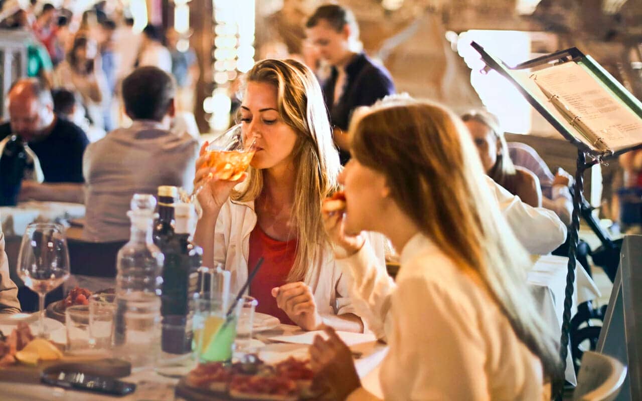 people in a restaurant enjoying food as a reward for completing a reading goal