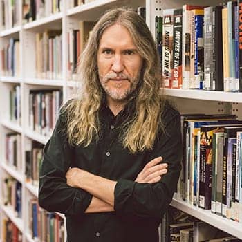 Image of Anthony Metivier in a library to illustrate principles related to how to teach yourself