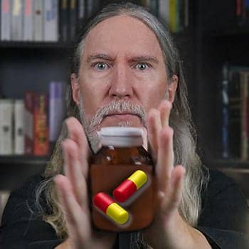 Vitamins for Memory Improvement feature image of Anthony Metivier holding a pill bottle