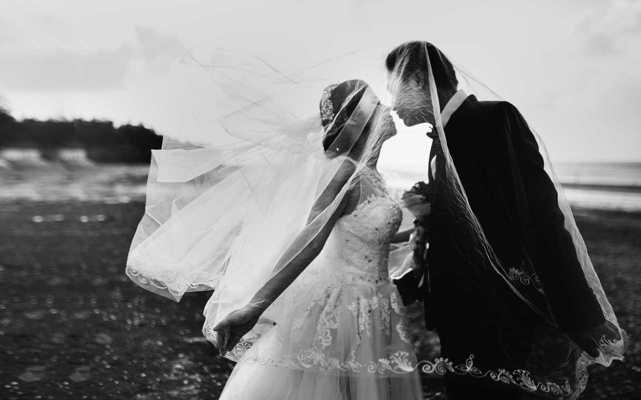 A bride and groom on the beach.